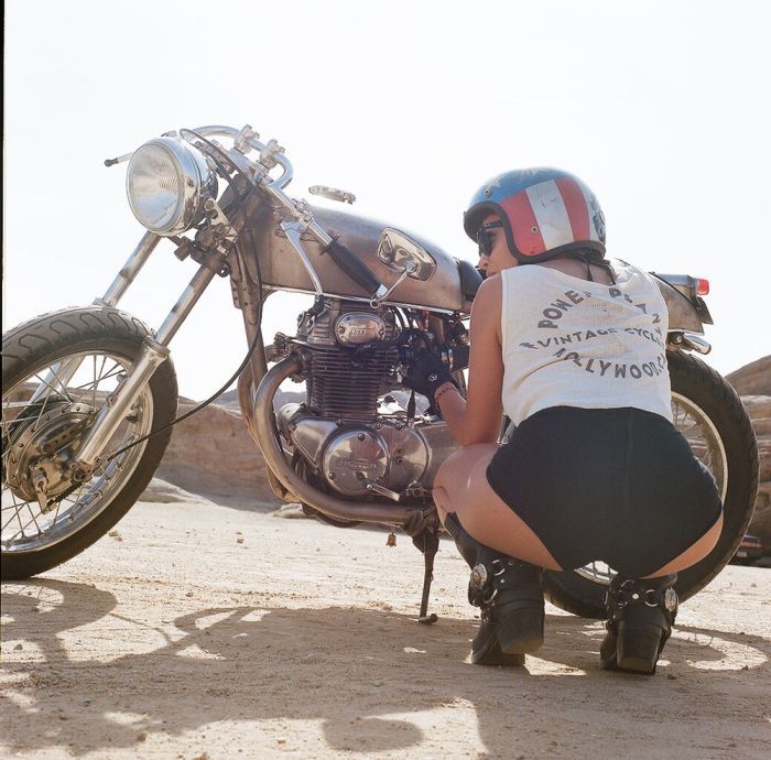 A playful frame from Girls on a motorcycle — online in Toronto